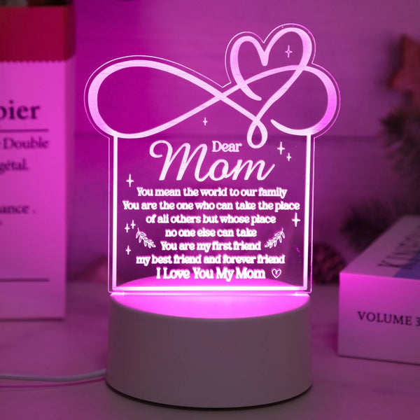 A glowing pink heart design on a white base, featuring a message to mom.