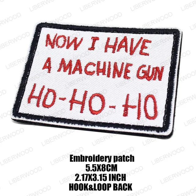 An embroidered patch with the text NOW I HAVE A MACHINE GUN HD-HO-HO on a white background.
