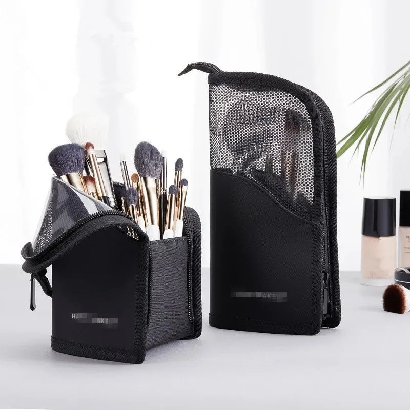 A black waterproof makeup brush holder with a foldable stand is shown next to various makeup brushes.