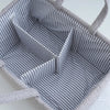 A gray, striped portable diaper bag organizer with bottle storage is shown from above.