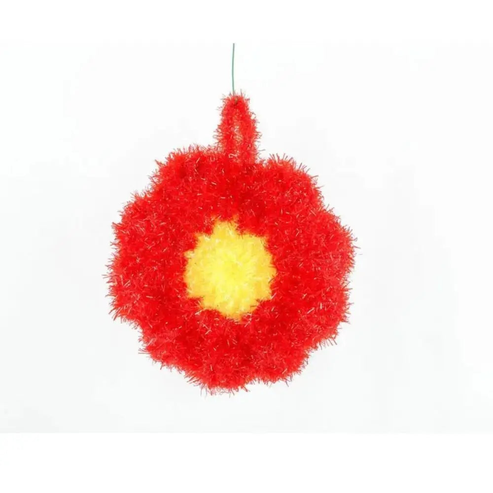 A bright red, fluffy acrylic non-stick dish sponge with a yellow center.