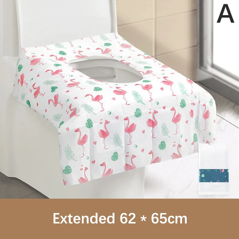 Pink and green patterned disposable toilet seat covers displayed on a white toilet seat.