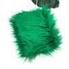 A vibrant green faux fur fabric with long, soft fibers.