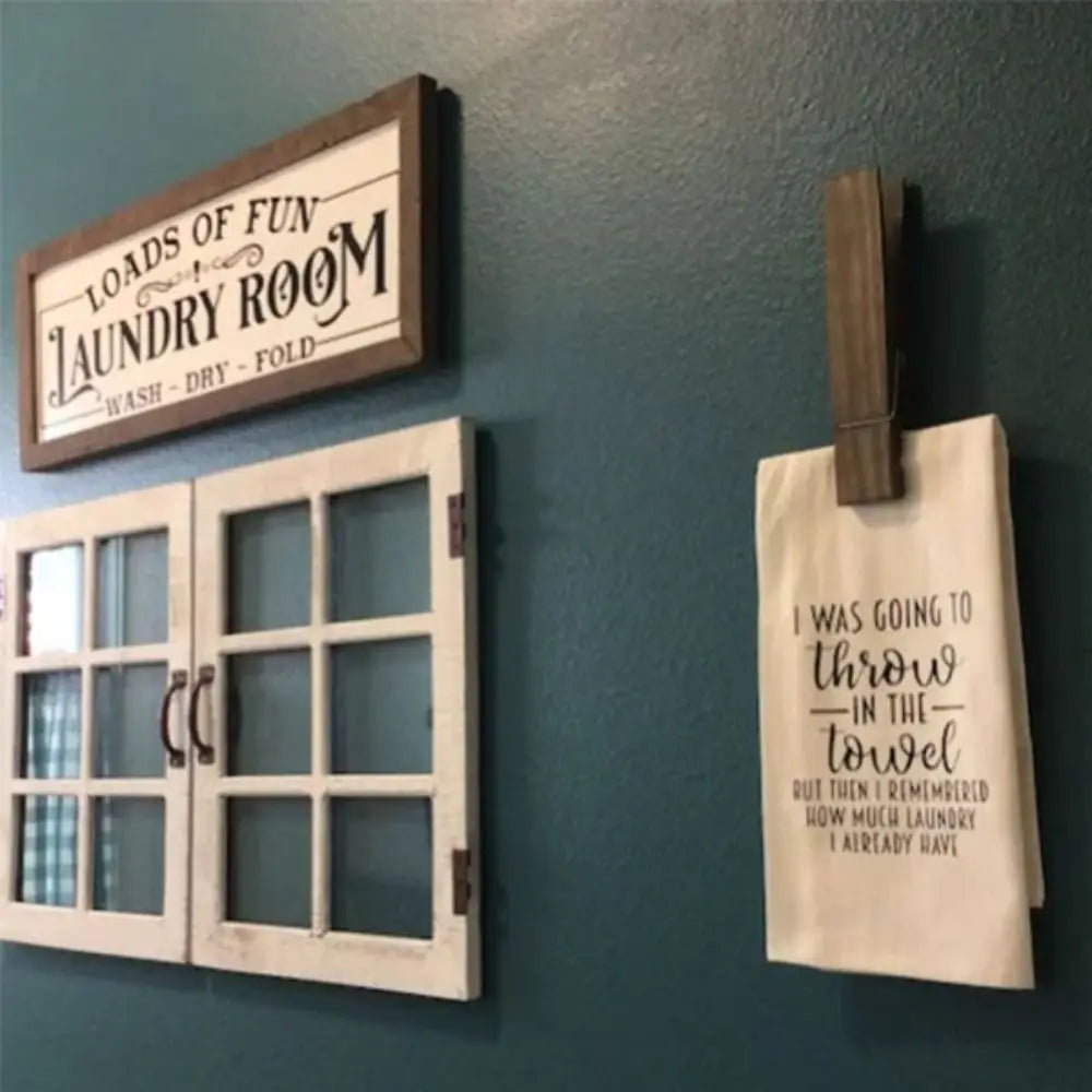 A rustic wooden wall-mounted towel clip with text that reads I was going to throw in the towel but i remembered how much laun