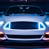 A white car's front grille features blue LED lights designed to look like demon eyes.