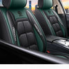Interior view of a car seat with green and black plaid fabric covers on the seats