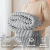 A person is holding a fluffy gray brushed flannel throw blanket, highlighting its ultra soft, lightweight, breathable, and ma