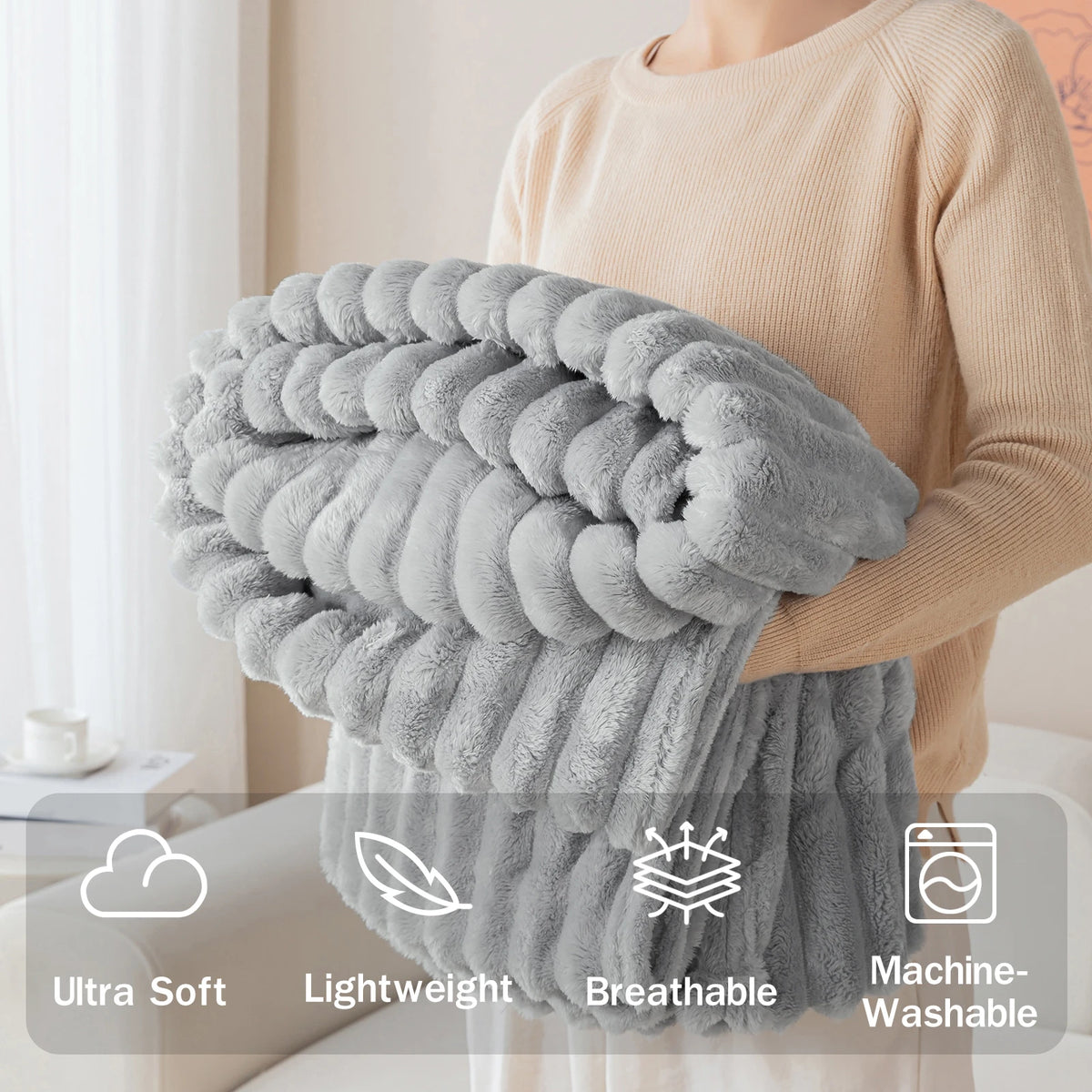 A person is holding a fluffy gray brushed flannel throw blanket, highlighting its ultra soft, lightweight, breathable, and ma