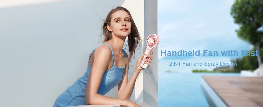 A woman holds a handheld fan with mist features in an outdoor setting.