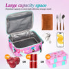 Pink insulated lunch bag with a zipper and adjustable strap, shown next to cutlery and a smartphone.