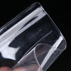 A close-up view of a transparent PVC jewelry pouch with a zip lock closure.