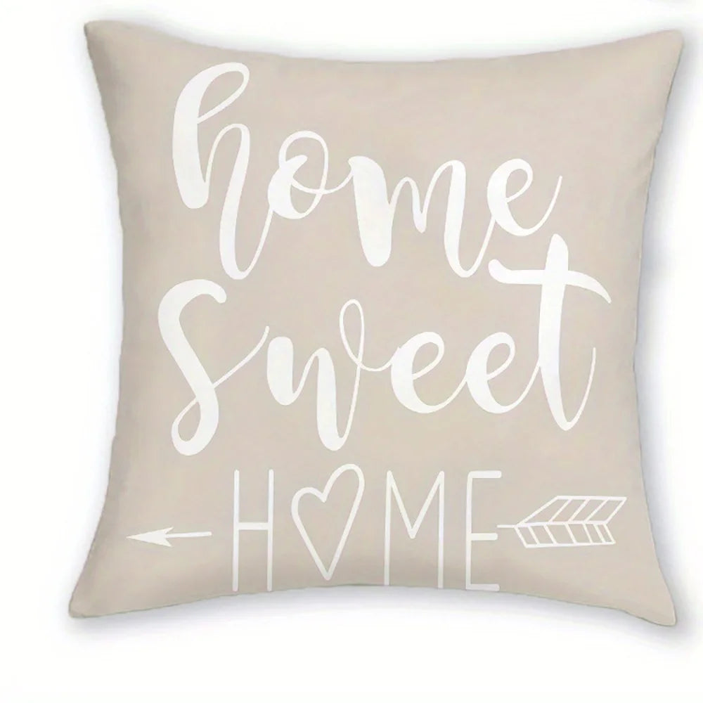 A beige decorative pillow featuring white script that reads Home Sweet Home
