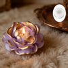 A purple rose-shaped silicone mold for crafts rests on a fluffy beige surface.