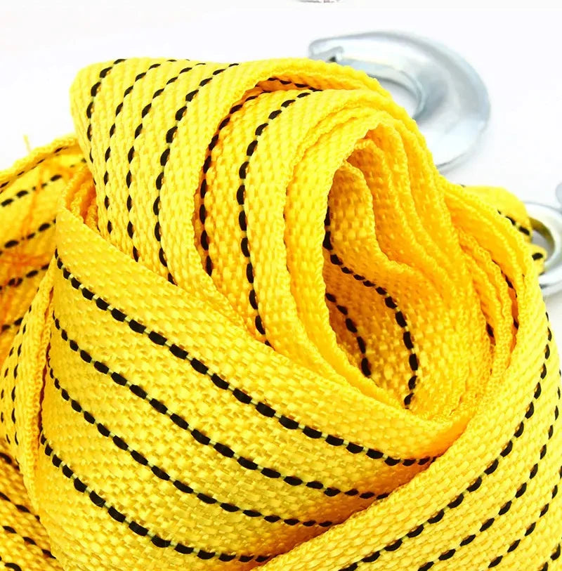 A coil of bright yellow heavy-duty vehicle recovery towing strap with black markings.