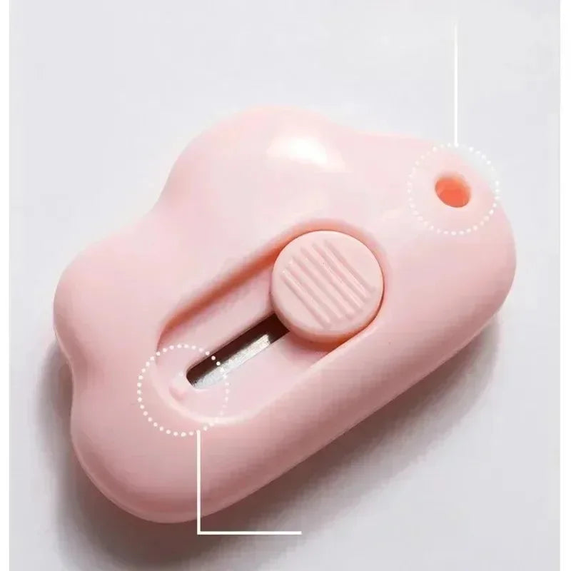 A pink compact rabbit mini cutter with a retractable blade is shown against a white background.