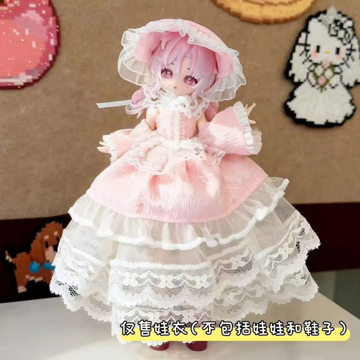 A pink sweet maid dress outfit for a doll featuring lace and frills.