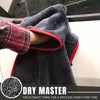 A dark gray microfiber drying towel is draped over a vehicle, showing its texture and red trim.