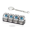A clear plastic LED macaron keyboard fidget toy keychain with a metal clip.