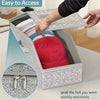 A gray fabric storage box with a zipper is shown open, displaying a red hat inside.