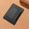 A black ultra-thin passport holder with card slots lying on a beige surface.