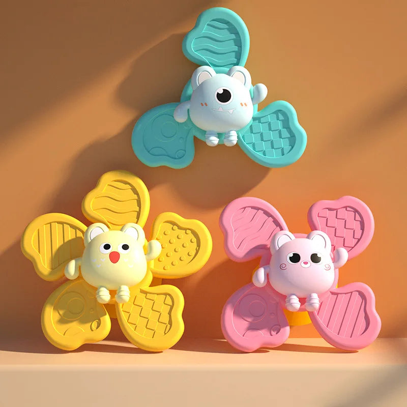 A set of three cute, light blue and pink suction cup spinner bath toys for toddlers.