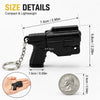 A black mini pistol-shaped keychain accessory with a silver chain and a US quarter coin for scale.