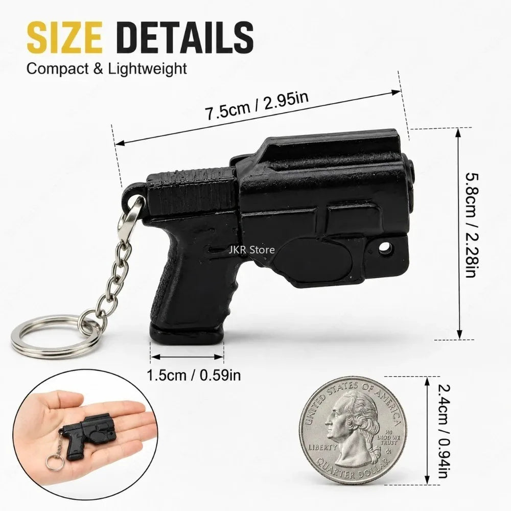 A black mini pistol-shaped keychain accessory with a silver chain and a US quarter coin for scale.