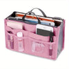 A pink foldable oxford cloth makeup organizer bag filled with various cosmetic and personal items.