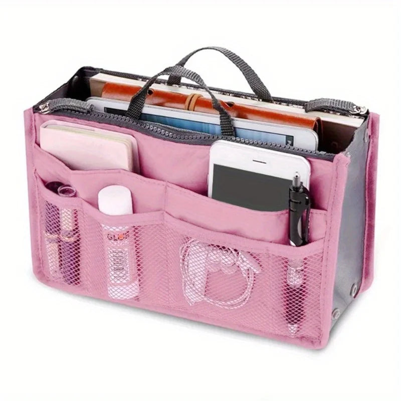 A pink foldable oxford cloth makeup organizer bag filled with various cosmetic and personal items.