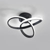 Modern clover-shaped LED ceiling light fixture with a black and white swirling design.