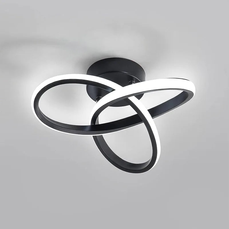 Modern clover-shaped LED ceiling light fixture with a black and white swirling design.