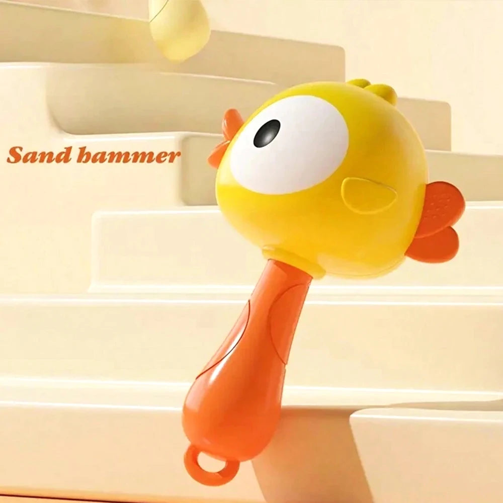 A yellow cartoon animal sand hammer toy with an orange handle resting on light-colored steps.