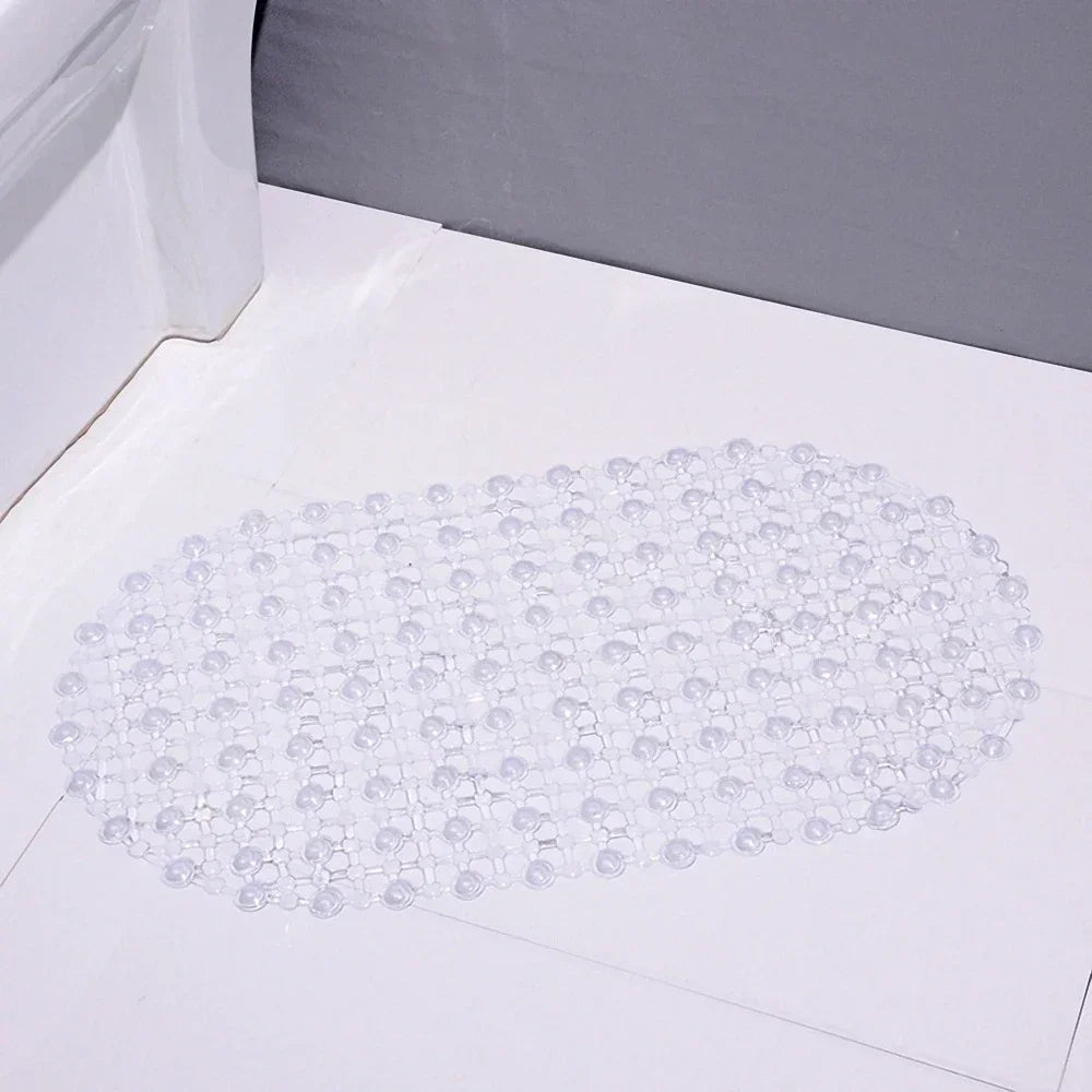 A clear non-slip PVC bath mat with numerous suction cups laid out on a white surface.