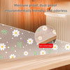 A white and green floral patterned kitchen drawer mat shown in a wooden cabinet setting.