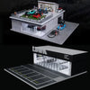 A detailed 1:64 scale miniature garage diorama kit featuring various cars and lighting elements.