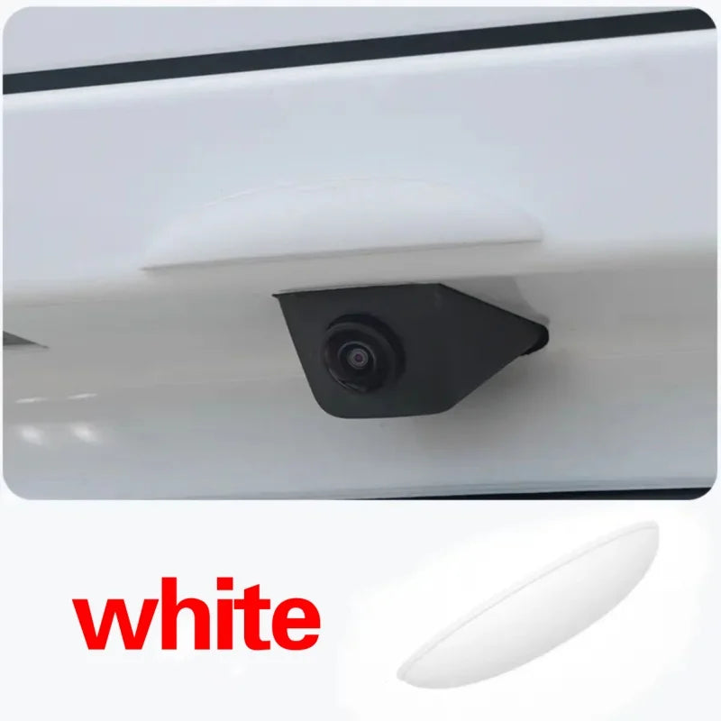 A white universal car rear camera rain cover shield is shown in a close-up view.