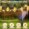 Outdoor string lights featuring IP44 waterproof, windproof, waterproof, snowproof, and sunproof bulbs hanging over a grassy a