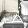 A white silicone squeegee broom is shown cleaning a floor surface with water and foam.