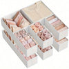 White foldable drawer organizer boxes containing various shades of pink and nude colored underwear, bras, and socks.