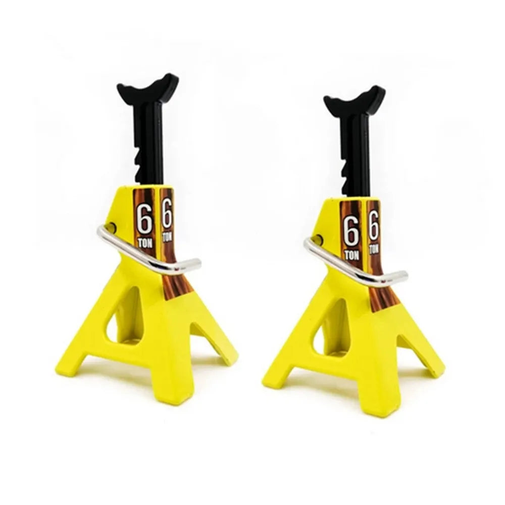 A pair of yellow metal RC jack stands with black handles and visible '6 TON' markings.