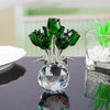 Crystal rose sculpture with a bouquet of green leaves and a clear glass base