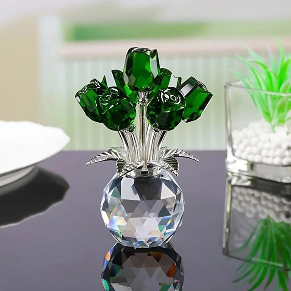 Crystal rose sculpture with a bouquet of green leaves and a clear glass base