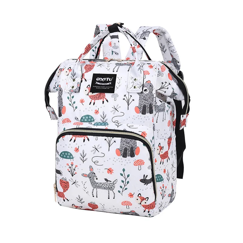 A white and black patterned waterproof diaper bag backpack with black straps and multiple pockets.