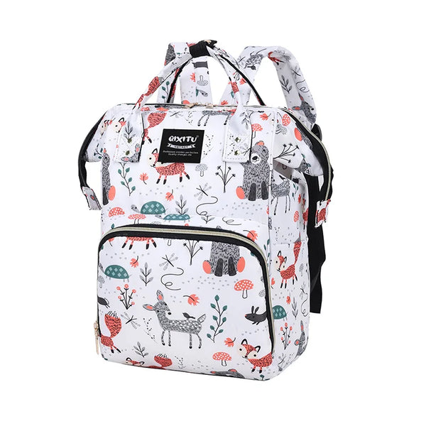 A white and black patterned waterproof diaper bag backpack with black straps and multiple pockets.