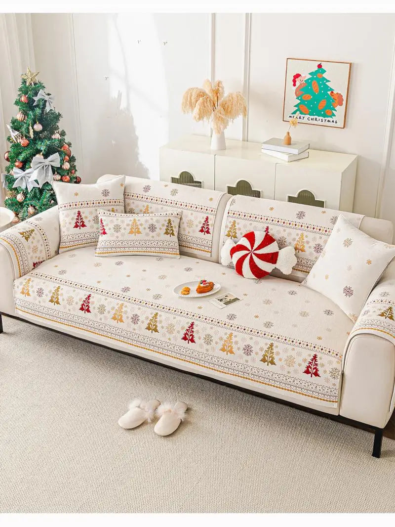 A beige chenille sofa covered with festive Christmas tree patterns and pillows, displayed in a bright room.