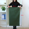A dark olive green heavy-duty canvas laundry bag hanging on a door, showing its dimensions.