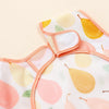 A peach and yellow patterned waterproof full-body baby feeding bib with a sleeveless design.