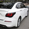 A white sedan with matte black headlight and taillight tint vinyl wrap film installed.