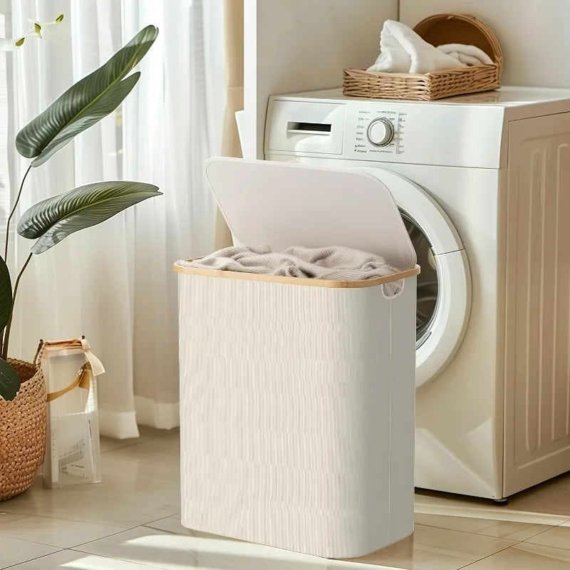 A large, beige foldable laundry hamper with a lid is placed in front of a white washing machine.