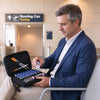 A man in a suit is preparing to use a portable EVA hard case for insulin and peptide vials.